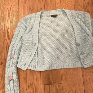 Cute and trendy preppy blue with flowers cropped sweater. Never been worn.
